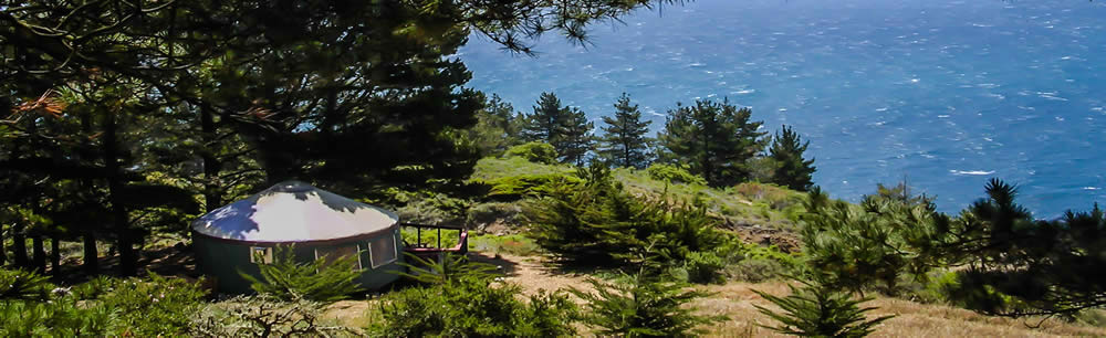 Rocky coast with little house and trees.